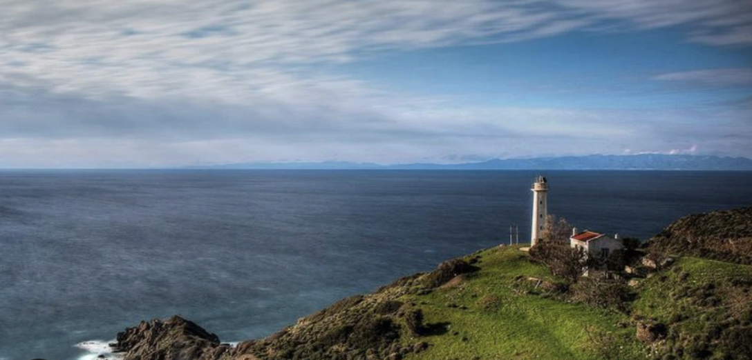 The Deveboynu lighthouse at the tip of Datça, on the rocks at dusk